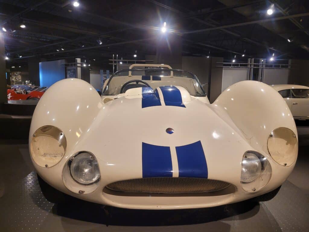 A white Maserati Birdcage racing car in a museum, front