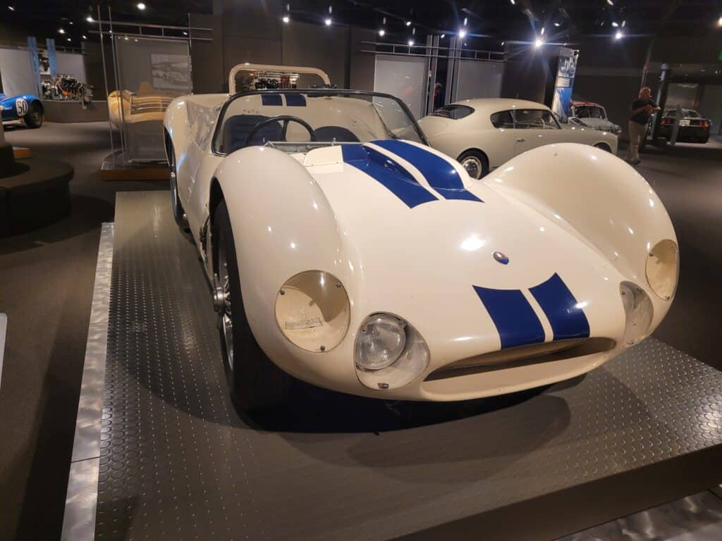 A white Maserati Birdcage racing car in a museum
