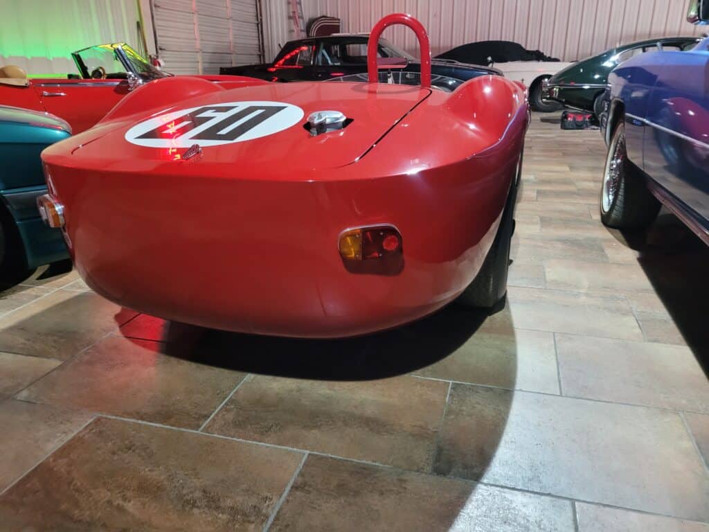 A red Maserati Birdcage racing car in a museum rear