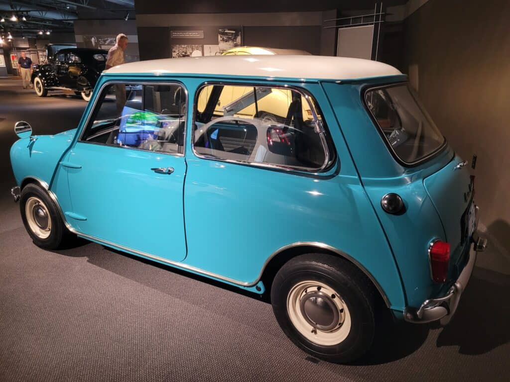 rear side view of a sky-blue Mini Cooper